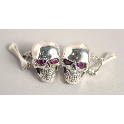 1645 - A PAIR OF SILVER SKULL CUFF LINKS.