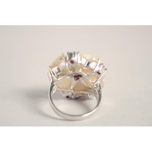 1650 - A SILVER MOTHER OF PEARL AND RUBY RING.