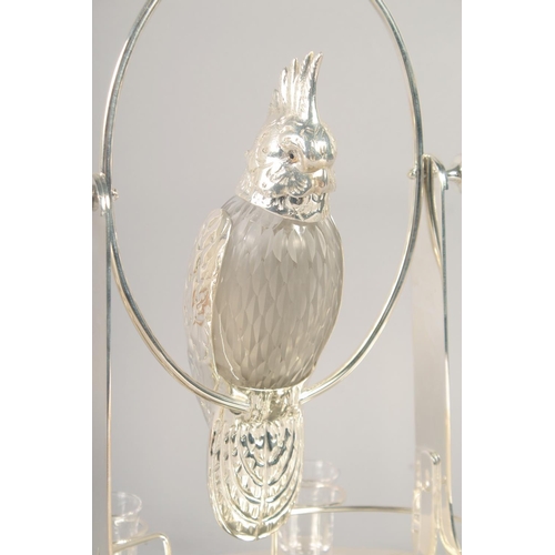 1671 - A GOOD SILVER PLATED AND GLASS LIQUEUR SET as a parrot on an oval base with six glasses. 15ins high.... 