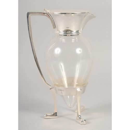 1672 - A CHRISTOPHER DRESSER STYLE SILVER PLATED AND GLASS CLARET JUG with crows feet.