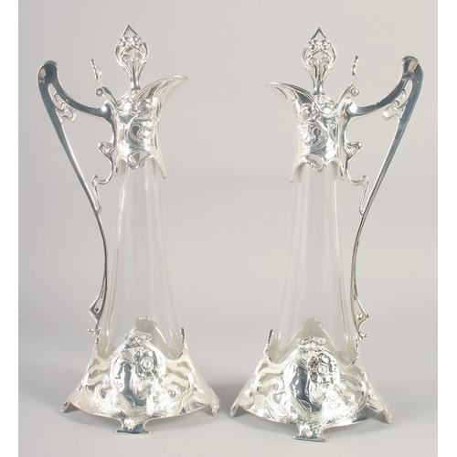 1674 - A GOOD PAIR OF W.A.P. PLATE AND GLASS TAPERING CLARET JUGS. 20ins high.