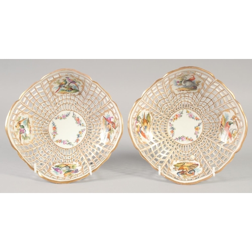 1064 - LATE 19TH CENTURY BERLIN PAIR OF PIERCED BASKETS each painted with four panels of birds, sceptre mar... 