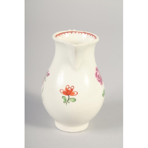 1065 - AN 18TH CENTURY WORCESTER JUG painted with a rose and rose bud with internal line and loop border.