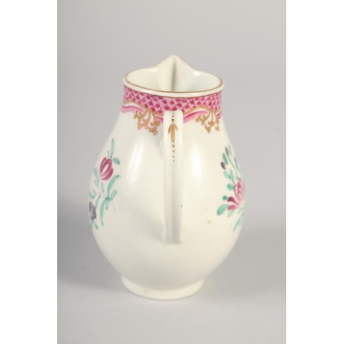 1069 - AN 18TH CENTURY WORCESTER JUG painted with flowers and an internal pink diaper border.