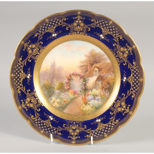 1081 - A ROYAL WORCESTER SUPERB PLATE painted with an English cottage having a floriferous garden ,the scen... 