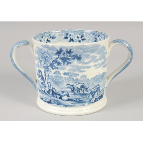 1082 - A STAFFORDSHIRE TWO HANDLED LOVING CUP printed with a farm scene