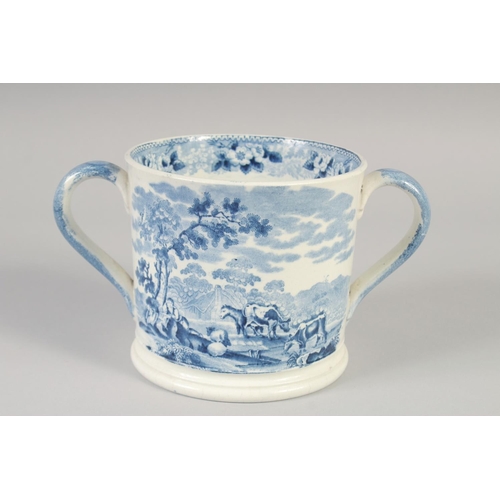 1082 - A STAFFORDSHIRE TWO HANDLED LOVING CUP printed with a farm scene