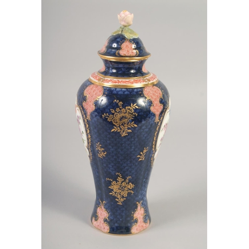 1090 - A ROYAL WORCESTER VASE AND COVER painted with flowers on a blue scale ground with red cell panels by... 