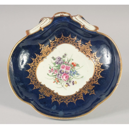 1094 - AN 18TH CENTURY WORCESTER WET BLUE SHELL SHAPED DISH painted with flowers under an elaborate gilt bo... 