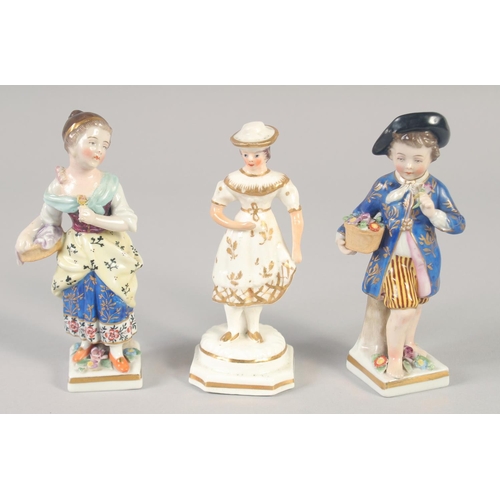 1095 - A 19TH CENTURY STAFFORDSHIRE PORCELAIN FIGURE OF A GIRL wearing a hat. and A PAIR OF CONTINENTAL FIG... 