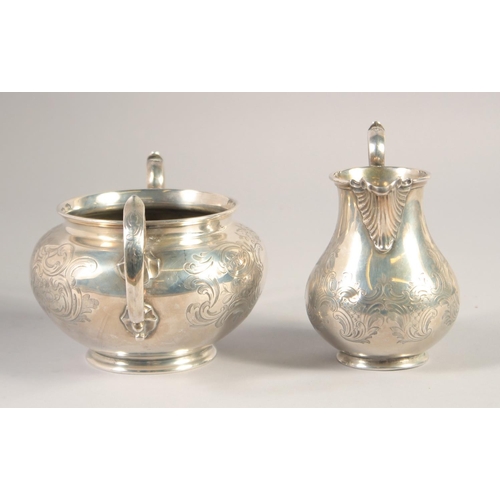 1701 - A VICTORIAN ENGRAVED SILVER TWO HANDLED CIRCULAR SUGAR BOWL AND MILK JUG. London 1848. Maker: Edward... 