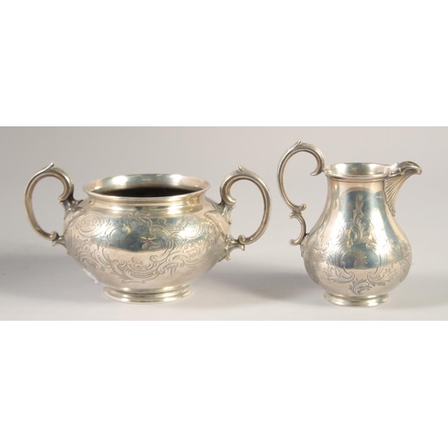 1701 - A VICTORIAN ENGRAVED SILVER TWO HANDLED CIRCULAR SUGAR BOWL AND MILK JUG. London 1848. Maker: Edward... 