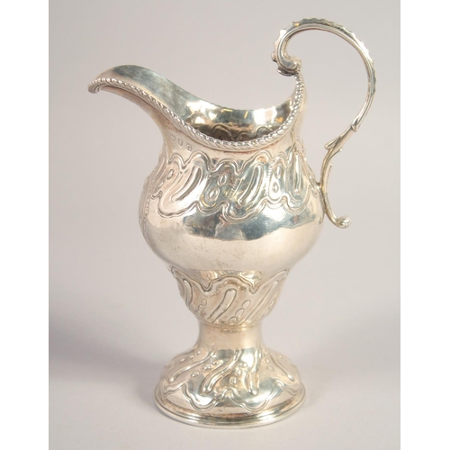 1705 - A LARGE III SILVER CREAM JUG with repousse decoration. London, 1768.