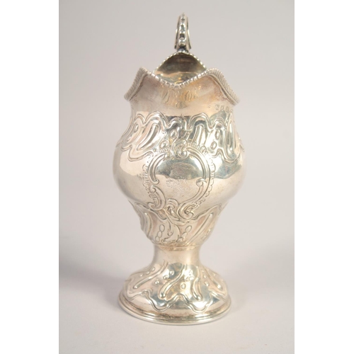 1705 - A LARGE III SILVER CREAM JUG with repousse decoration. London, 1768.