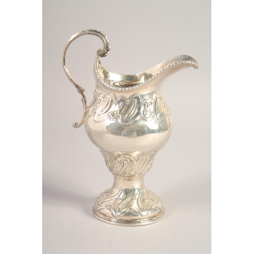 1705 - A LARGE III SILVER CREAM JUG with repousse decoration. London, 1768.