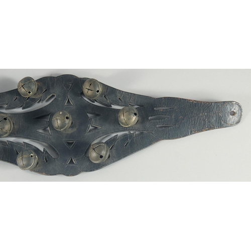 10 - A HORSES LEATHER GIRTH STRAP, with fifteen brass bells, 40cm long.