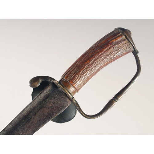 114 - AN ENGLISH HUNTING HANGER, circa 1700, curved fullered blade, embossed brass shell guard, down turne... 