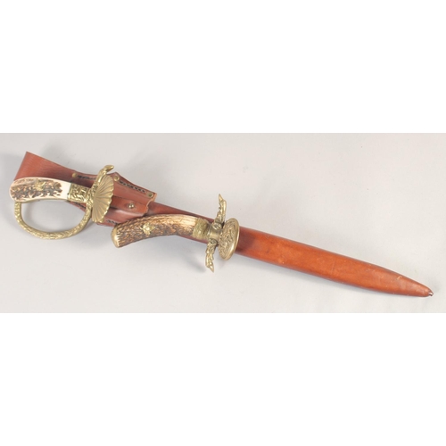 122 - A HUNTING TROUSSEAU, mid-20th century, comprising sword with straight fullered 16in blade, brass she... 