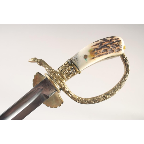 122 - A HUNTING TROUSSEAU, mid-20th century, comprising sword with straight fullered 16in blade, brass she... 