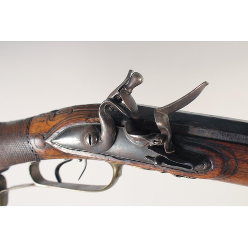 152 - A GERMAN FLINTLOCK SPORTING GUN, dated 1768, 13 bore octagonal 29.5 in barrel, indistinctly signed &... 