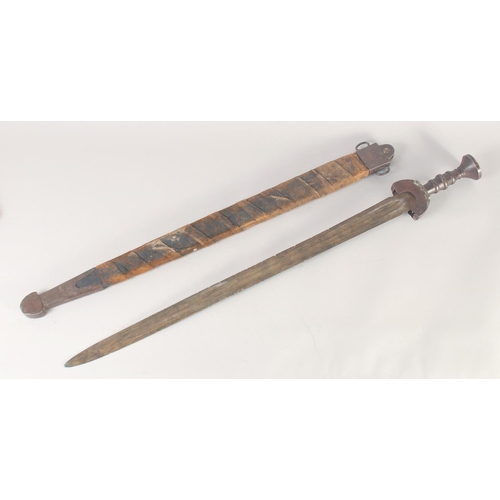 180 - A THEATRICAL REPLICA OF AN IRON AGE SWORD, early 20th century, wide tapering double fullered pointed... 