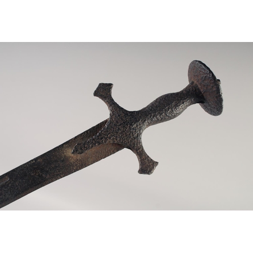 222 - AN INDIAN TULWAR, mid-18th century, 28in fullered blade and typical hilt, overall rusted.