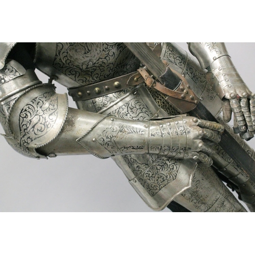 229 - A GOOD 19th CENTURY FULL ARMOUR, deeply etched all over with foliate scrolls and mythical beasts on ... 