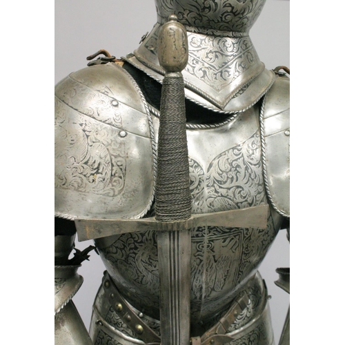 229 - A GOOD 19th CENTURY FULL ARMOUR, deeply etched all over with foliate scrolls and mythical beasts on ... 