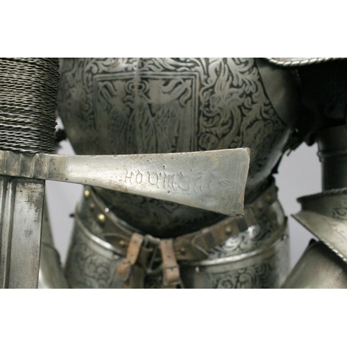 229 - A GOOD 19th CENTURY FULL ARMOUR, deeply etched all over with foliate scrolls and mythical beasts on ... 