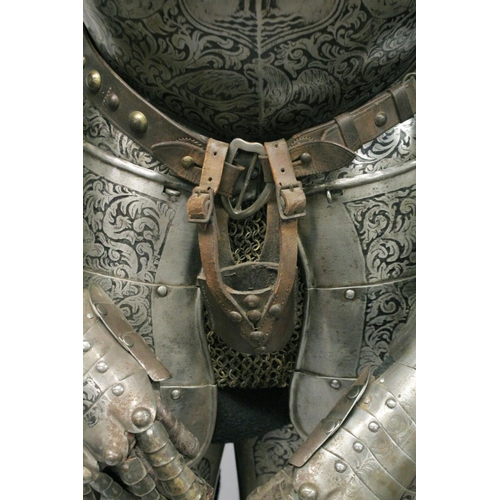 229 - A GOOD 19th CENTURY FULL ARMOUR, deeply etched all over with foliate scrolls and mythical beasts on ... 