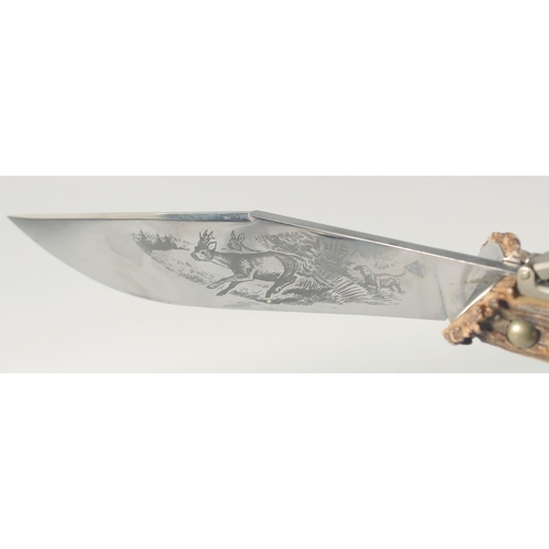 27 - INDIANA INOX, A LARGE HUNTING KNIFE, the blade engraved with two deer and a dog, blade 12