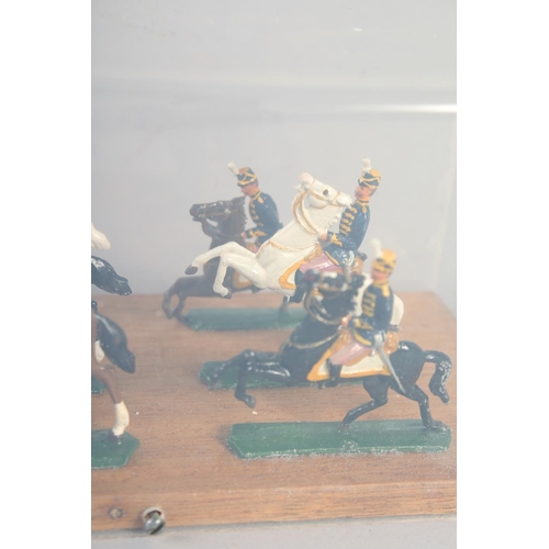 278 - A DIECAST SET, of twelve mounted cavalry, in a Perspex case.