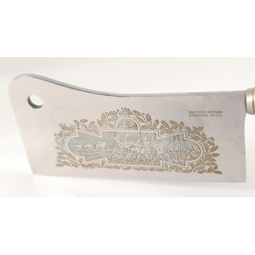 42 - A SOLINGEN STAINLESS STEAL CLEAVER, the blade engraved with a deer, with an antler handle, 10.5