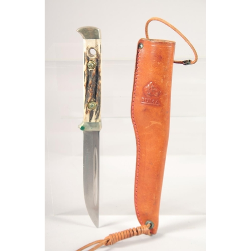 48 - THE 6383 PUMA BUDDY KNIFE, with super keen cutting steel, antler handle in a leather sheath.