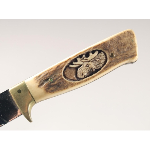 49 - A KNIFE, with antler handle carved with a moose head, 9