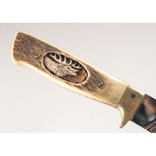 49 - A KNIFE, with antler handle carved with a moose head, 9