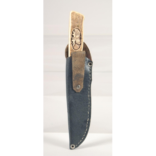 49 - A KNIFE, with antler handle carved with a moose head, 9