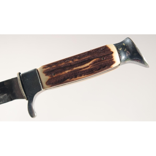 52 - A KNIFE, with thumb guard and antler handle, in a leather sheath, 8