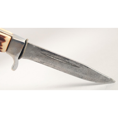 52 - A KNIFE, with thumb guard and antler handle, in a leather sheath, 8