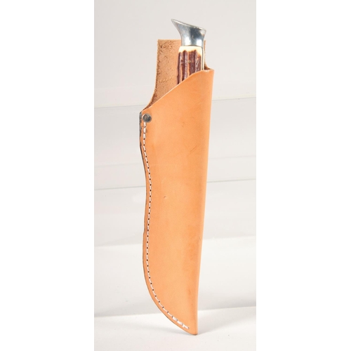 52 - A KNIFE, with thumb guard and antler handle, in a leather sheath, 8