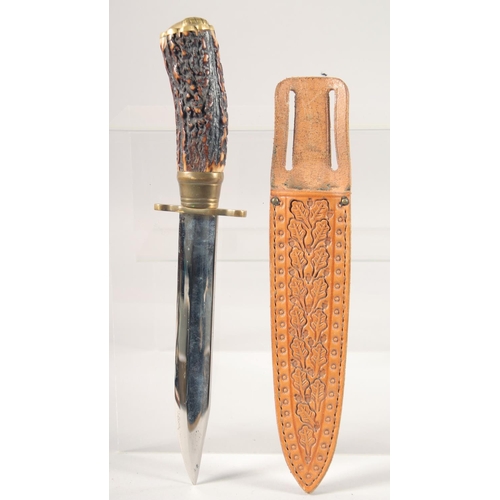 53 - A KNIFE, with brass mounts and antler handle, in a sheath with oak leaves, 10