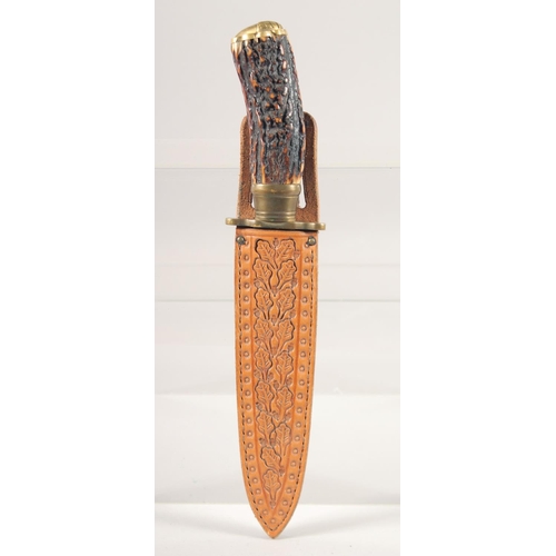 53 - A KNIFE, with brass mounts and antler handle, in a sheath with oak leaves, 10