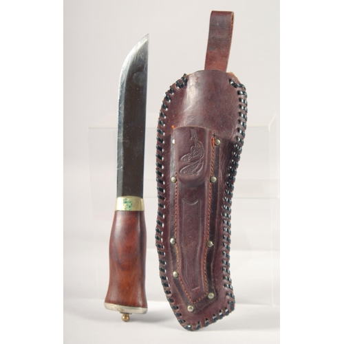 55 - A KNIFE, with wooden handle, in a leather sheath, 11