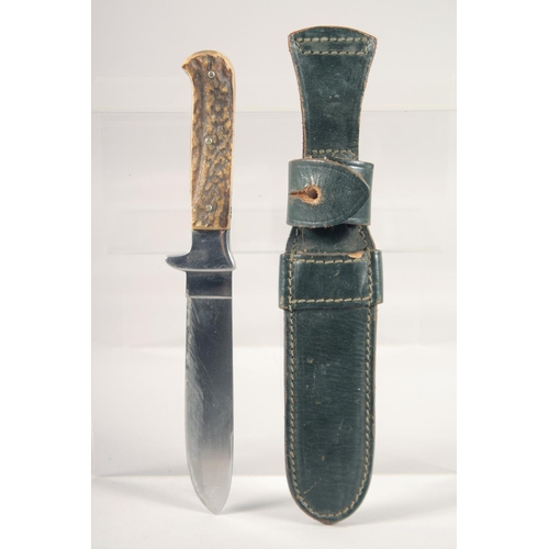 72 - A KNIFE, with antler handle in a sheath, 9