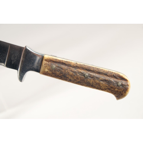 72 - A KNIFE, with antler handle in a sheath, 9