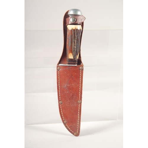 73 - A KNIFE, with antler handle, in a sheath with a deer. 8.5