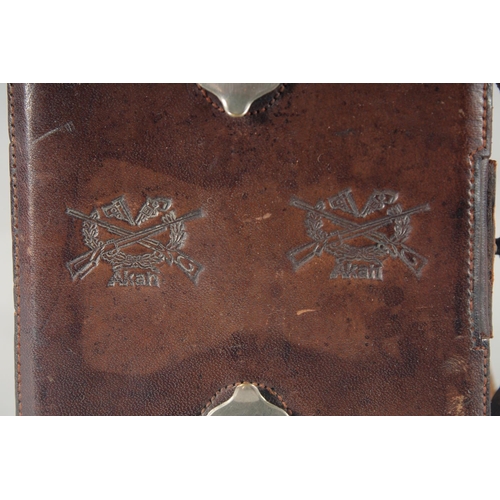 9 - A LEATHER CARTRIDGE CASE 17cm x 11cm, with cross guns in relief and leather strap.