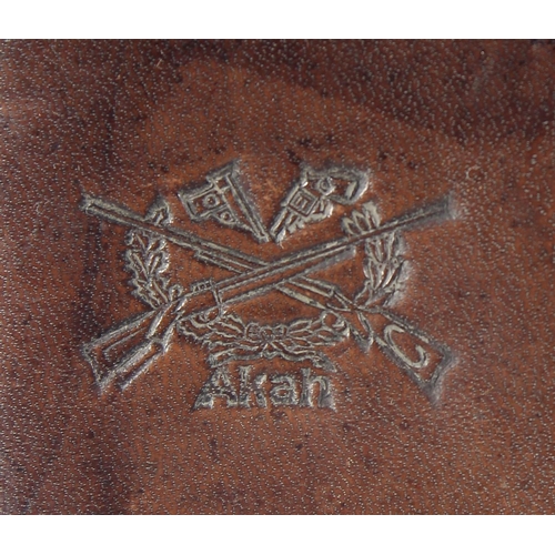 9 - A LEATHER CARTRIDGE CASE 17cm x 11cm, with cross guns in relief and leather strap.