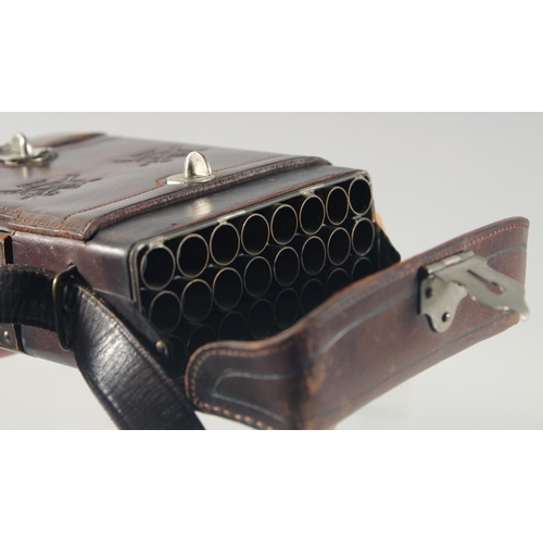 9 - A LEATHER CARTRIDGE CASE 17cm x 11cm, with cross guns in relief and leather strap.