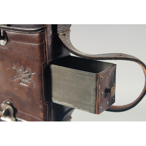 9 - A LEATHER CARTRIDGE CASE 17cm x 11cm, with cross guns in relief and leather strap.